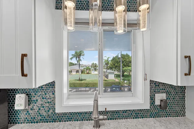 a kitchen with stainless steel appliances granite countertop white cabinets and a stove a refrigerator with wooden floor