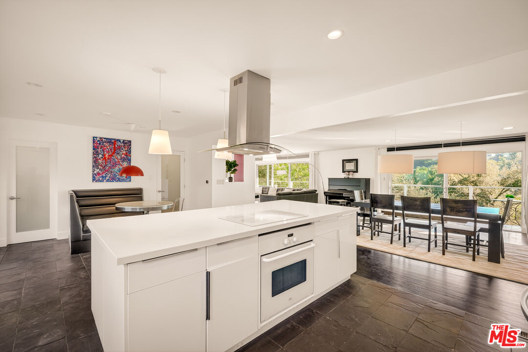 2388 Kimridge Road Beverly Hills, CA 90210 - Photo 12 of 54 a kitchen that has a lot of cabinets in it and wooden floors