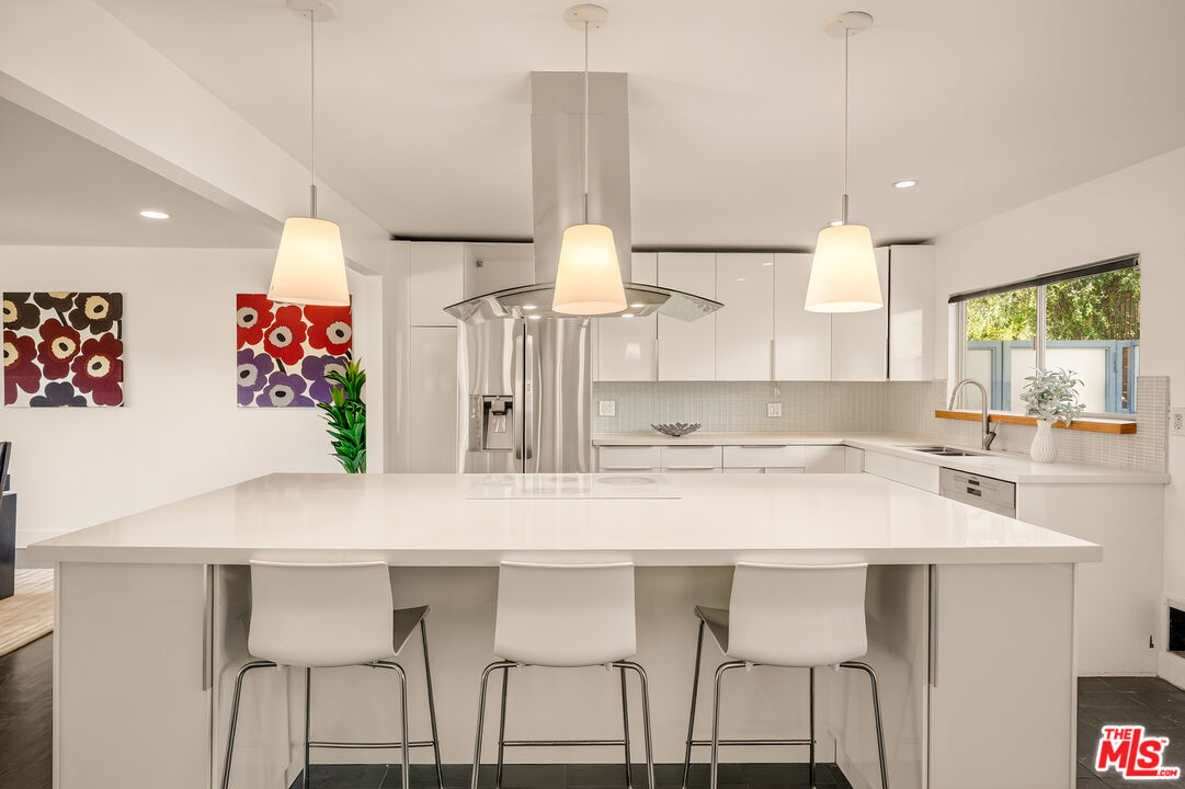2388 Kimridge Road Beverly Hills, CA 90210 - Photo 14 of 54 a kitchen with a table and chairs in it