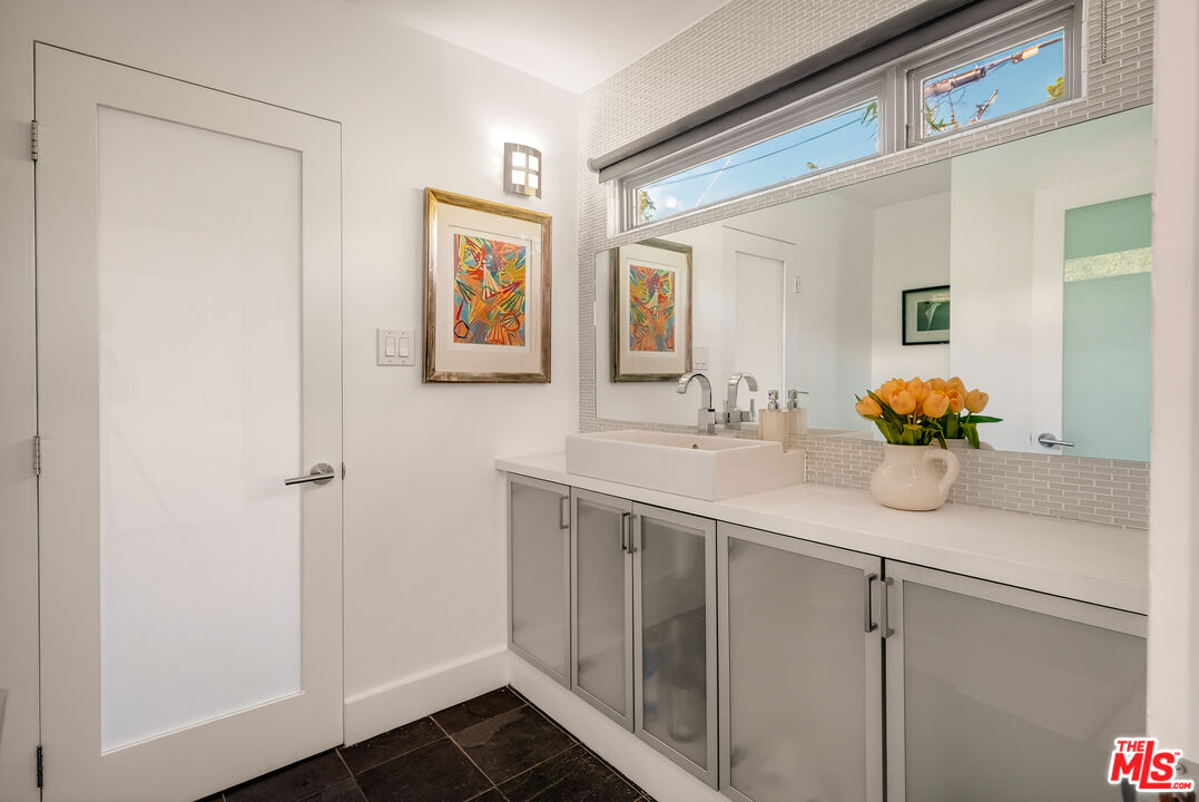 2388 Kimridge Road Beverly Hills, CA 90210 - Photo 18 of 54 a bathroom with a sink and a mirror