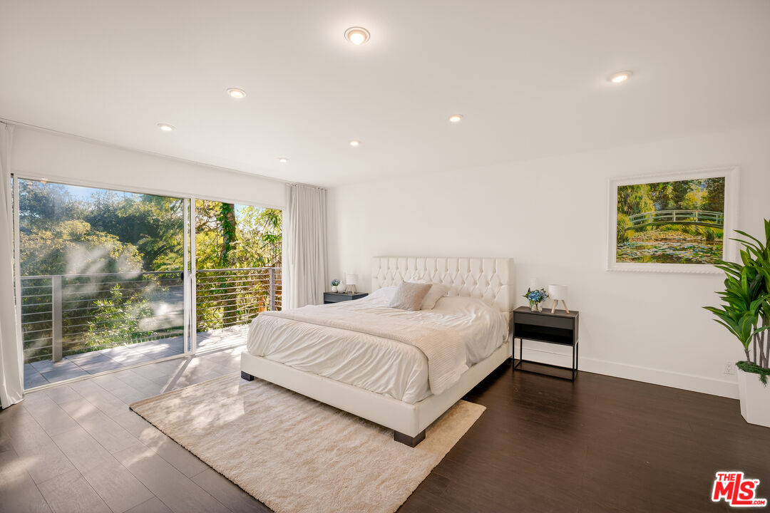 2388 Kimridge Road Beverly Hills, CA 90210 - Photo 21 of 54 a bedroom with a large bed and a large window