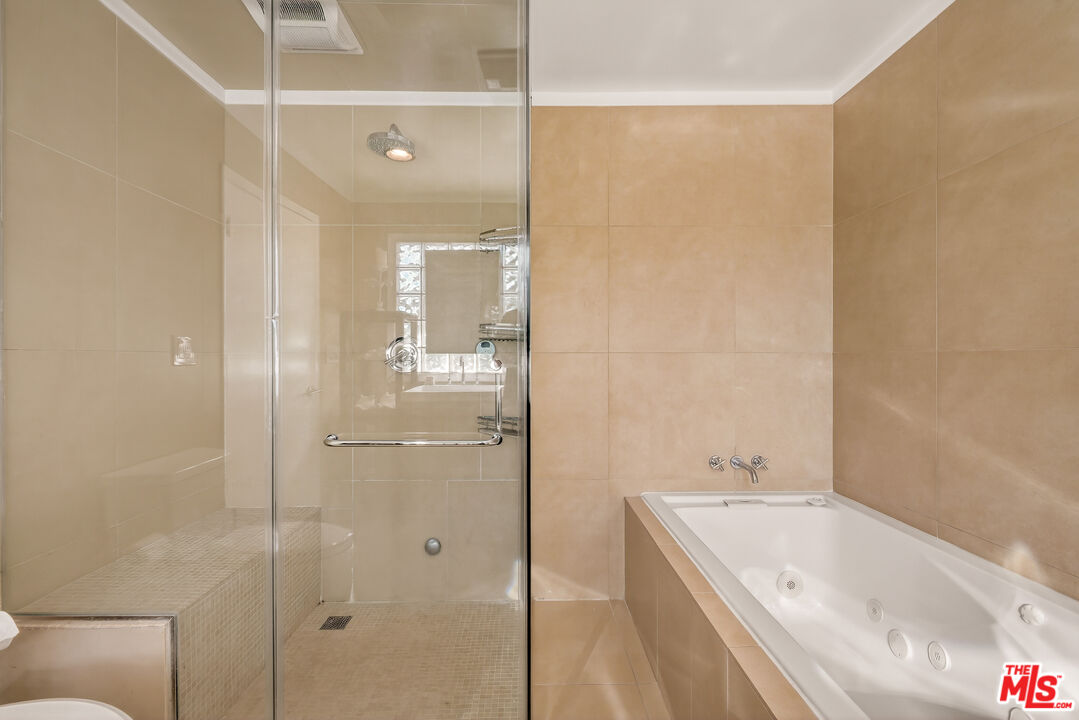 2388 Kimridge Road Beverly Hills, CA 90210 - Photo 25 of 54 a bathroom with a tub sink shower and mirror