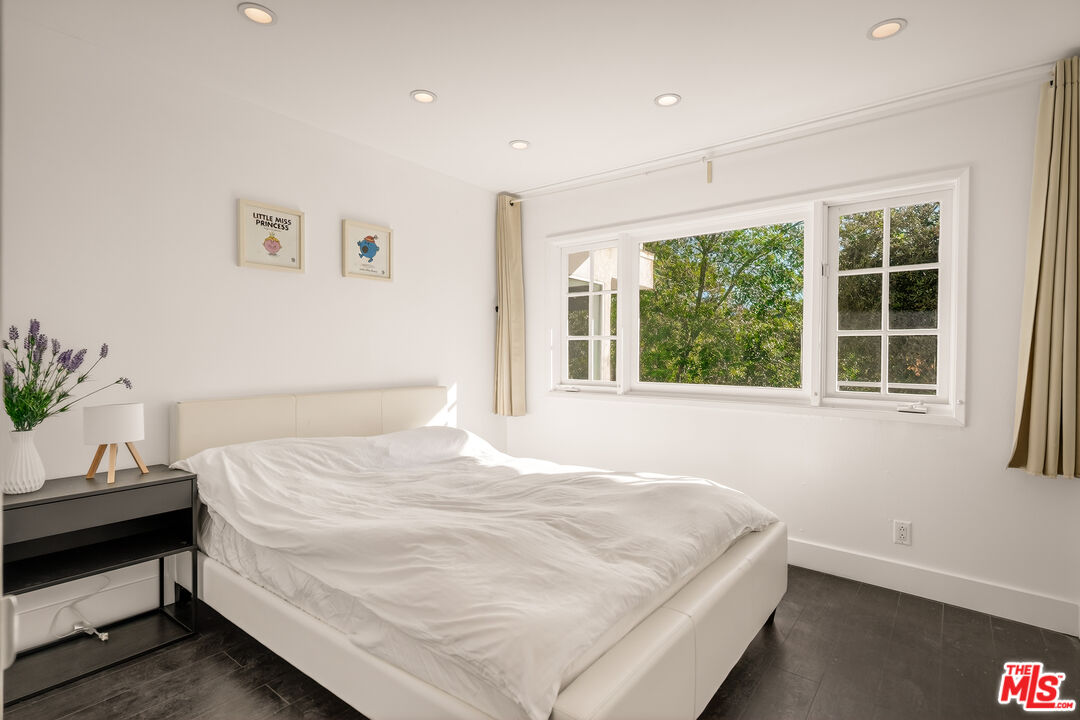 2388 Kimridge Road Beverly Hills, CA 90210 - Photo 29 of 54 a bedroom with a bed and a window