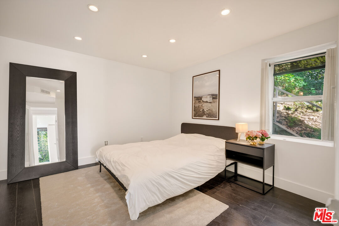 2388 Kimridge Road Beverly Hills, CA 90210 - Photo 33 of 54 a bedroom with a bed and a window