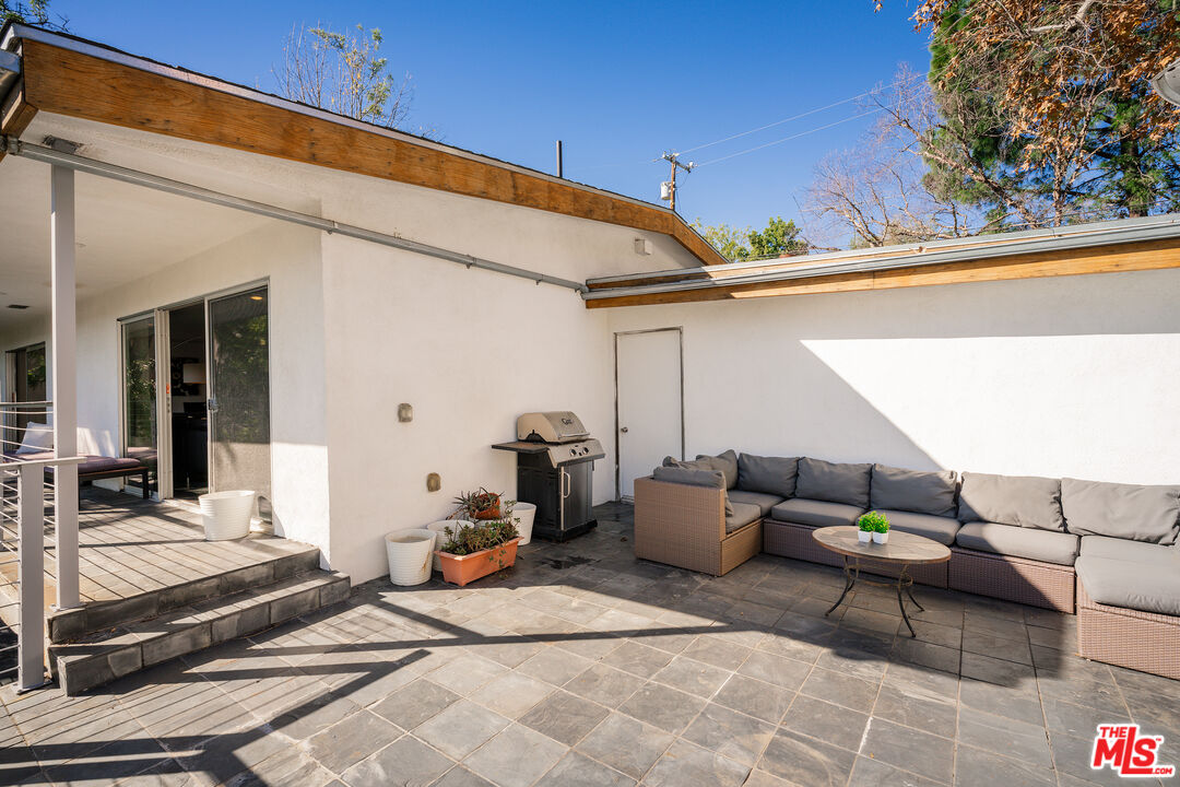 2388 Kimridge Road Beverly Hills, CA 90210 - Photo 49 of 54 a balcony with furniture and outdoor seating