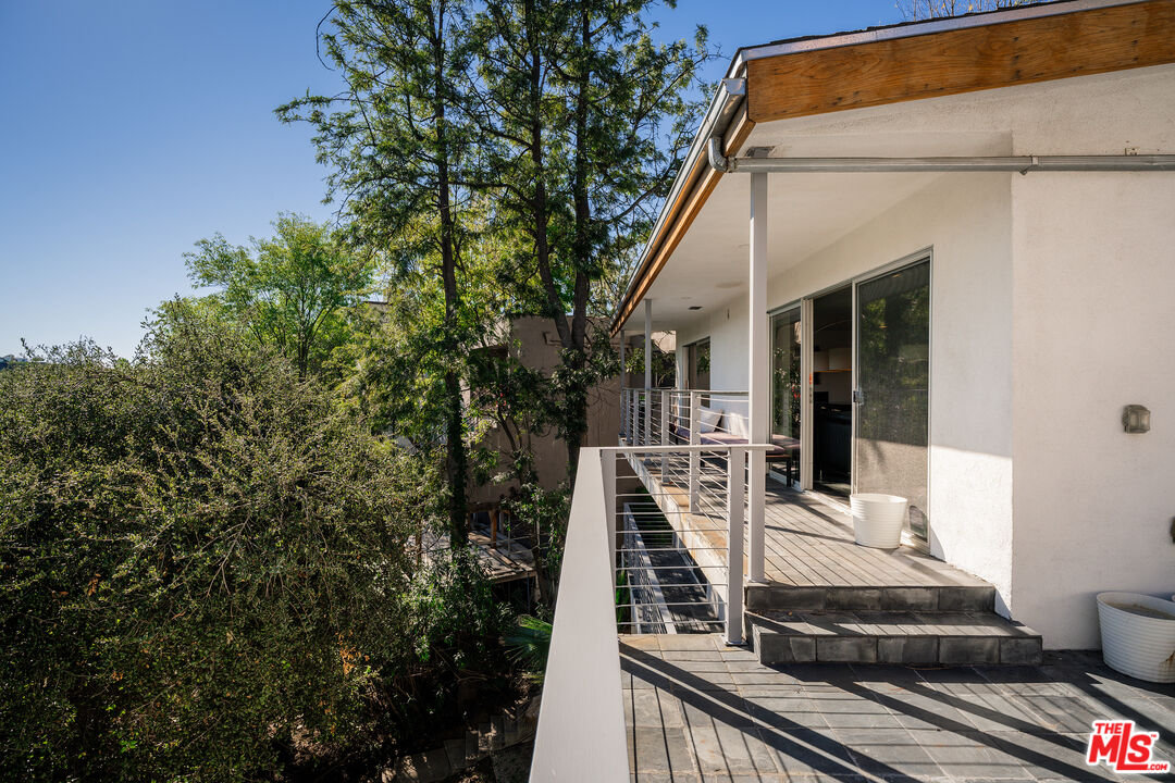 2388 Kimridge Road Beverly Hills, CA 90210 - Photo 51 of 54 a view of a white house with large windows