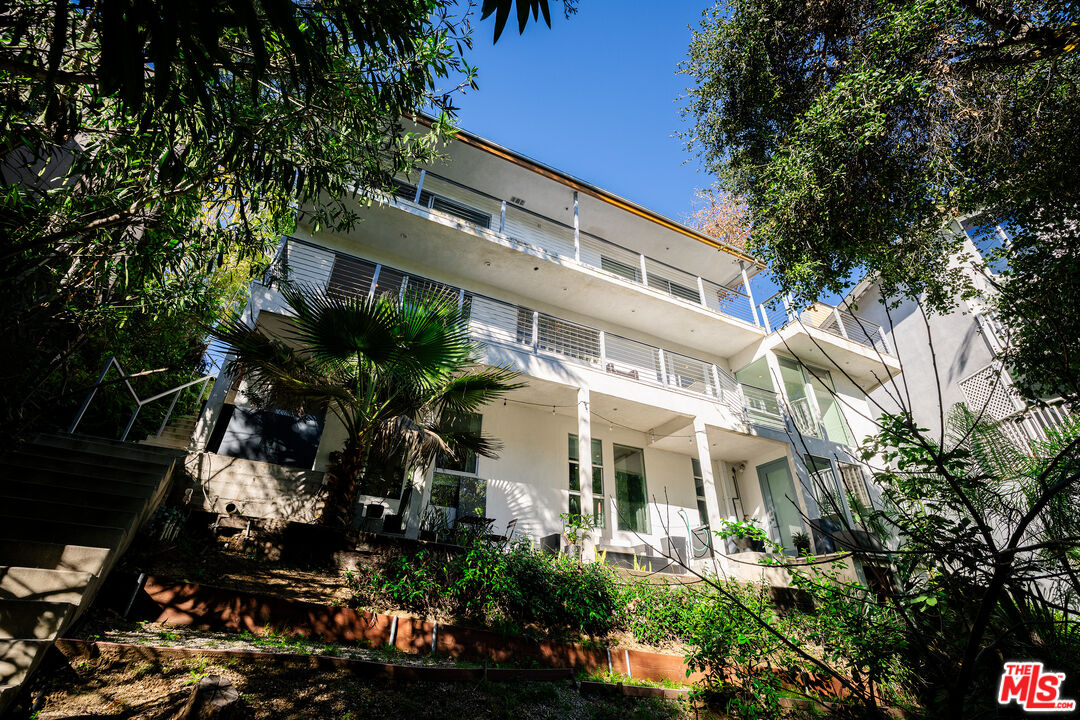 2388 Kimridge Road Beverly Hills, CA 90210 - Photo 52 of 54 a view of a white house with a tree