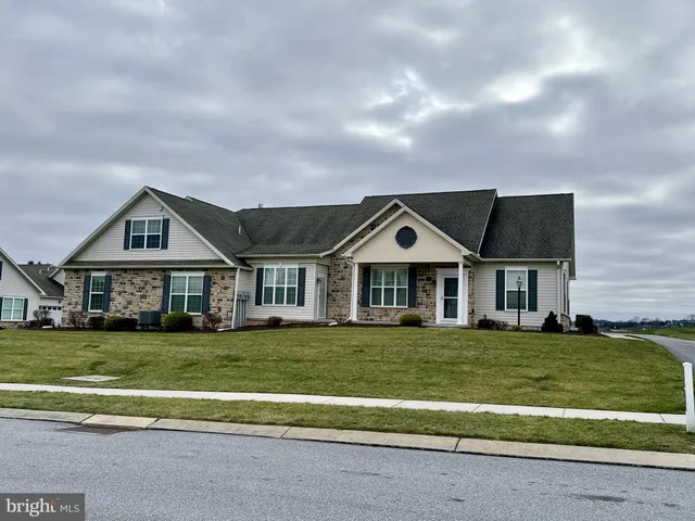 a white house sitting in middle of a grassy field