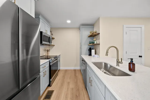 a kitchen with a sink and a refrigerator