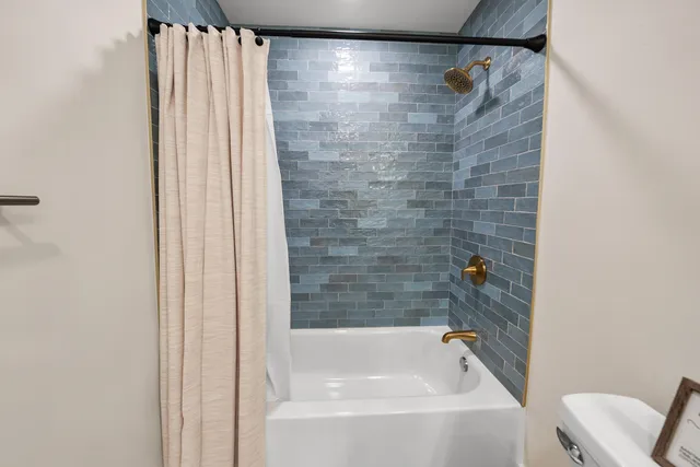 a bathroom with a shower and a bath tub