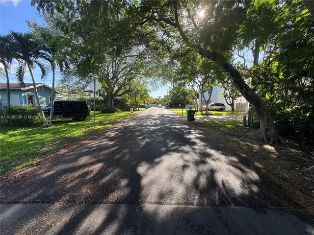 a view of a park with large trees