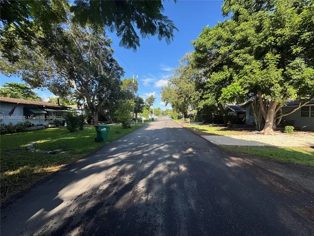 a view of yard with swimming pool and green space