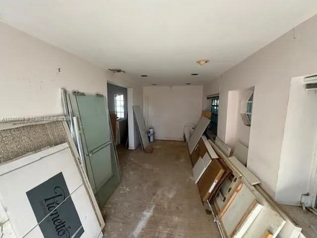 a view of a storage & utility room with closet fridge