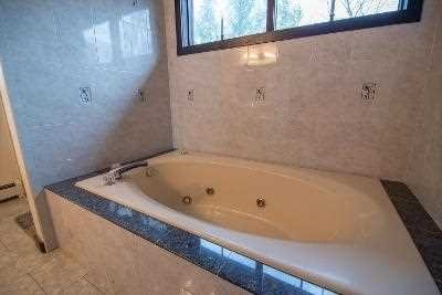 44 Flower Road East Fishkill, NY 12533 - Photo 21 of 30 a bath tub sitting in a bathroom next to a window