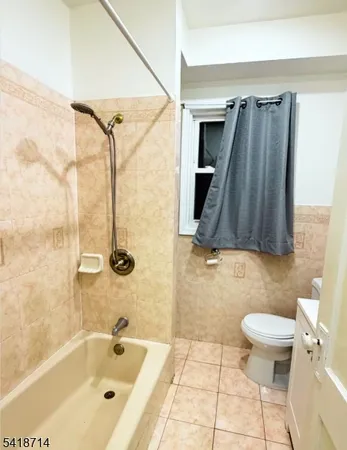 a bathroom with a shower a toilet and a sink