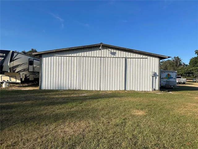 a kitchen with a table chairs sink and cabinets