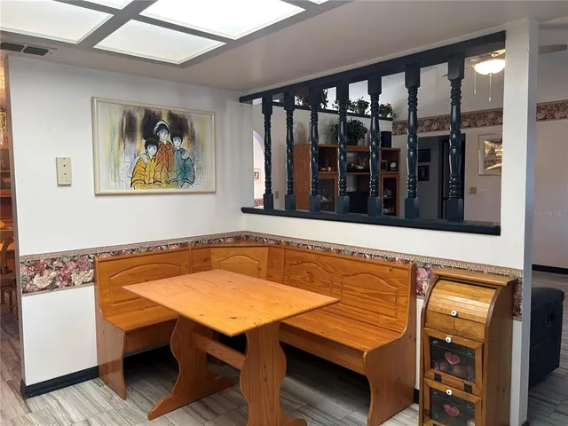 a kitchen with kitchen island granite countertop a refrigerator stove top oven and sink