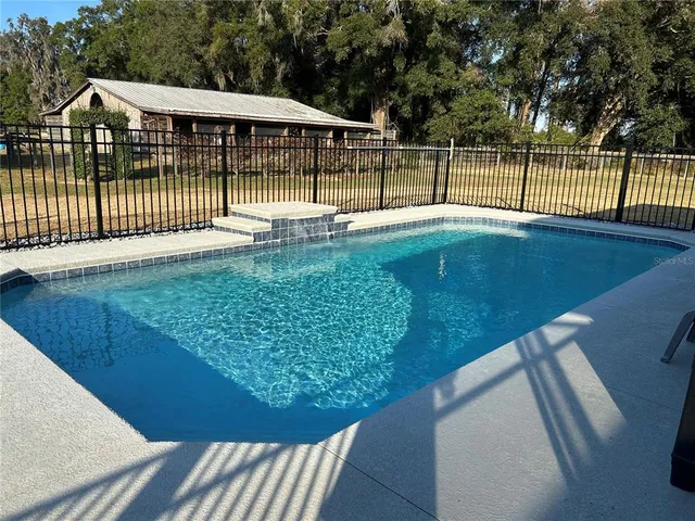 a view of pool of water and yard