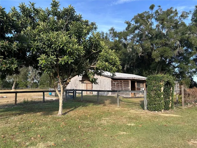 a view of outdoor space with swimming pool and trees in the background