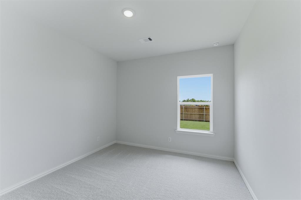 3504 Helena Street Gainesville, TX 76240 - Photo 12 of 19 Neutral-toned room featuring a single window, recessed lighting, light gray wall paint, white trim, and gray carpeting