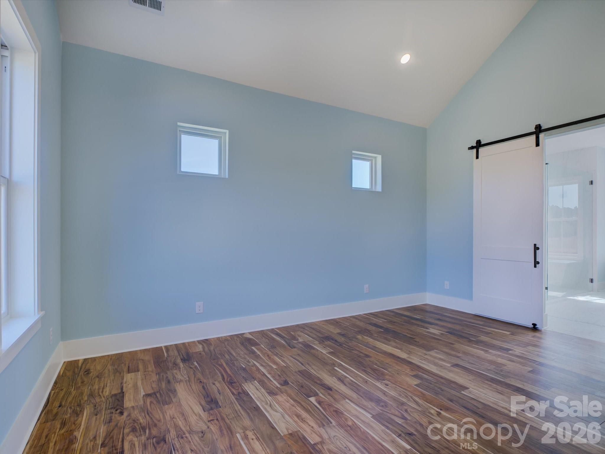 2334 Bridgewater Road, Unit 6 Rock Hill, SC 29730 - Photo 18 of 47 a view of an empty room with wooden floor and a window