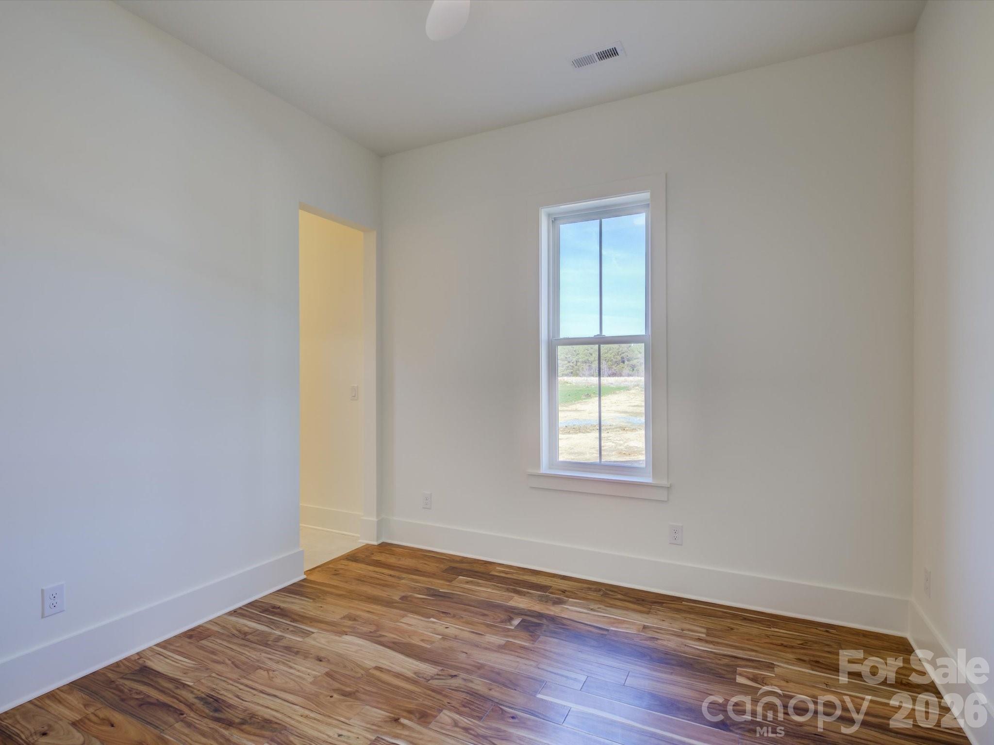 2334 Bridgewater Road, Unit 6 Rock Hill, SC 29730 - Photo 29 of 47 a view of an empty room with wooden floor and a window