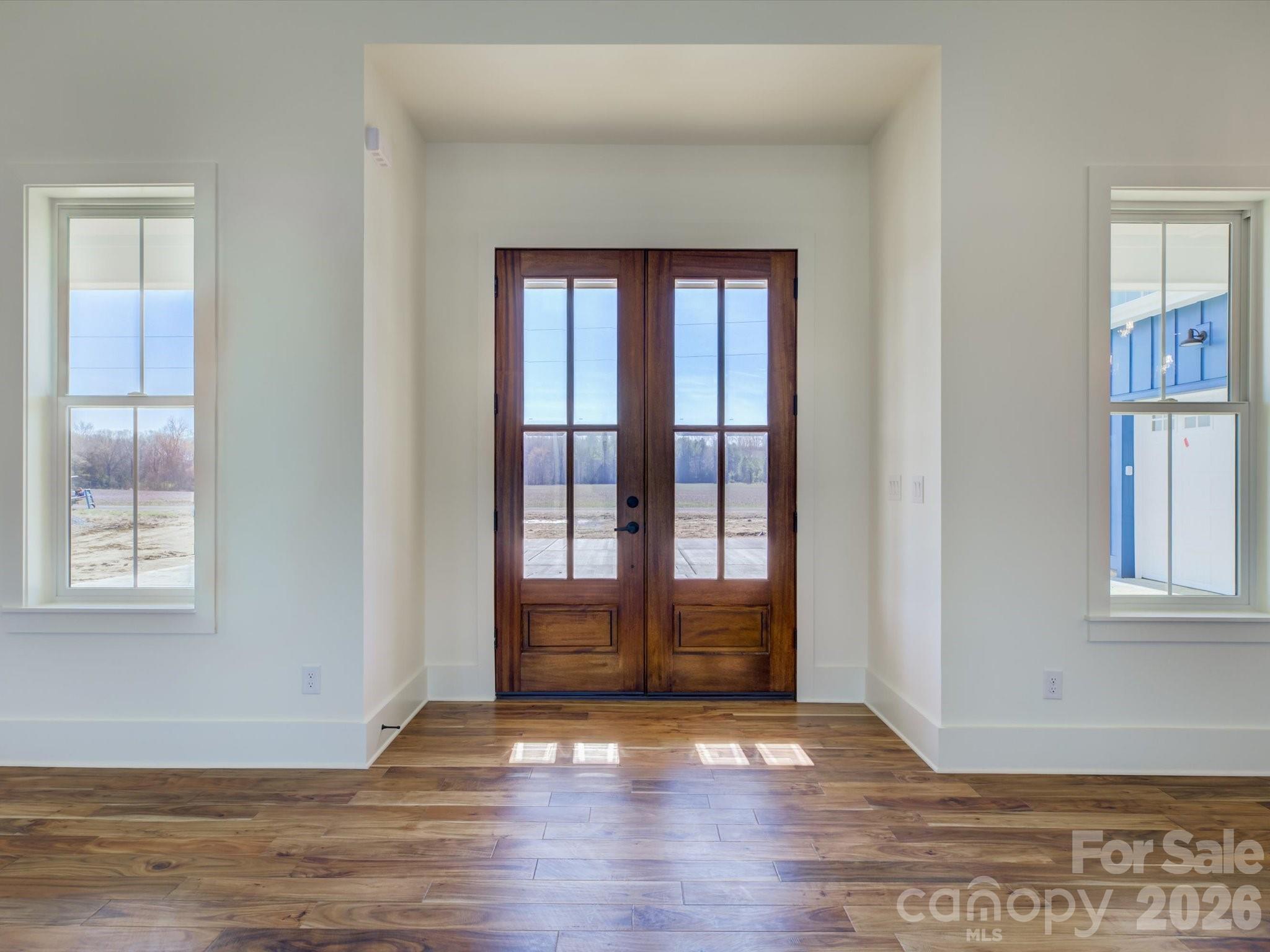 2334 Bridgewater Road, Unit 6 Rock Hill, SC 29730 - Photo 3 of 47 a view of an empty room with wooden floor and a window