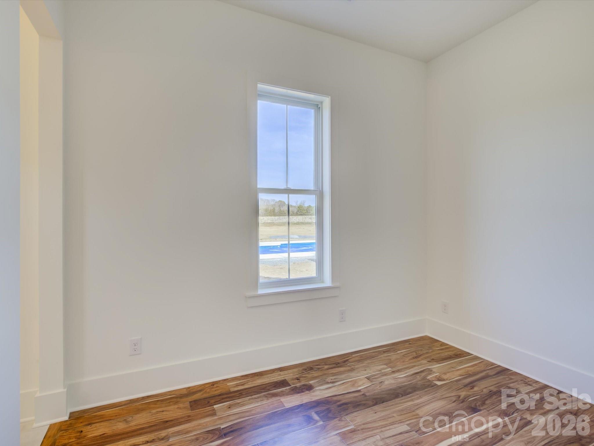 2334 Bridgewater Road, Unit 6 Rock Hill, SC 29730 - Photo 31 of 47 a view of an empty room with wooden floor and a window