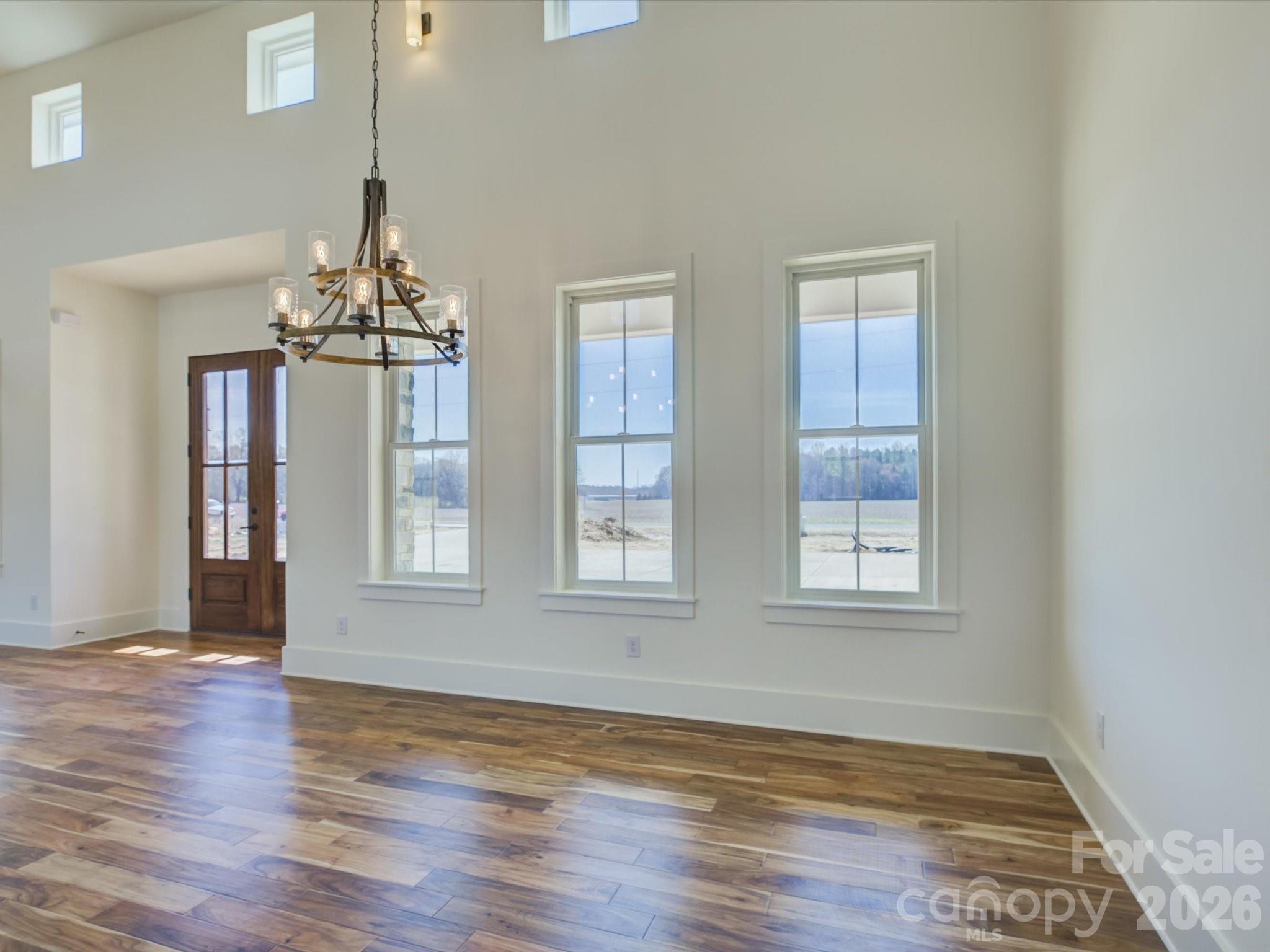 2334 Bridgewater Road, Unit 6 Rock Hill, SC 29730 - Photo 5 of 47 a view of an empty room with wooden floor and a window