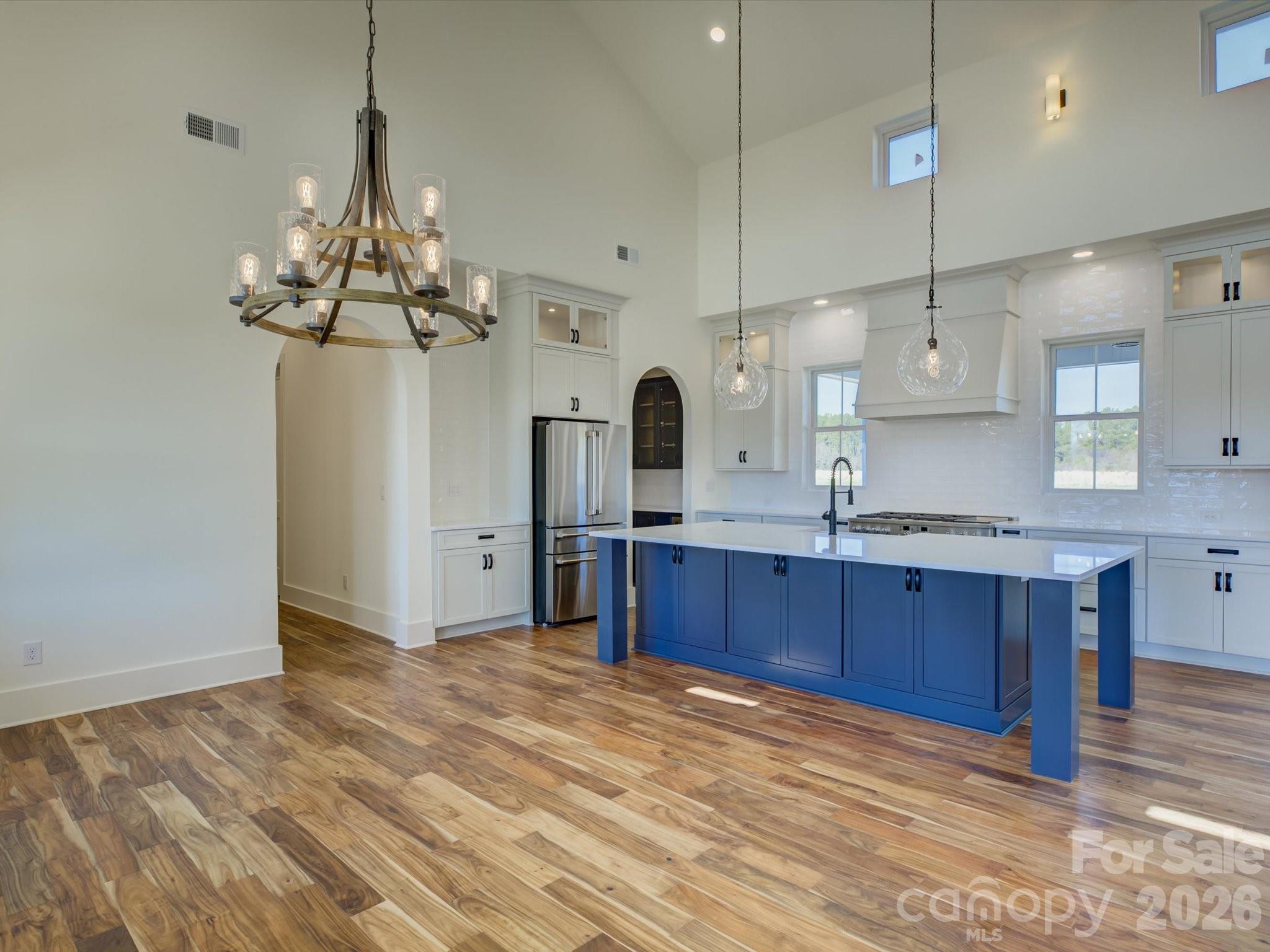 2334 Bridgewater Road, Unit 6 Rock Hill, SC 29730 - Photo 6 of 47 a kitchen with stainless steel appliances granite countertop a refrigerator a sink dishwasher a oven and a dining table with wooden floor