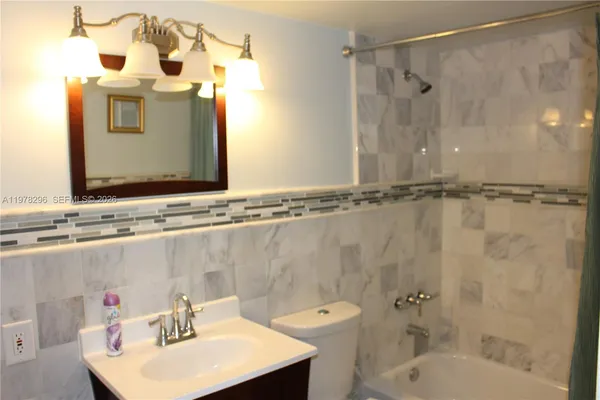 a bathroom with a sink a mirror and a shower