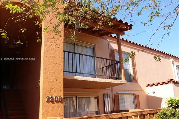 front view of a house with a tree