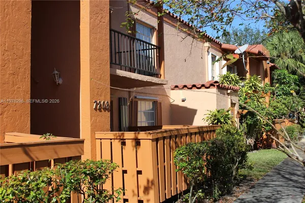 a view of a chairs and table in the balcony
