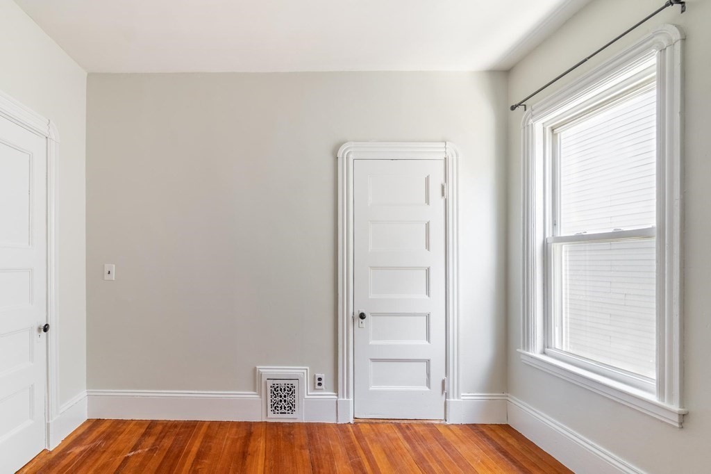 789 Columbia Road, Unit 2 Boston, MA 02125 - Photo 13 of 19 a view of bedroom with window and wooden floor