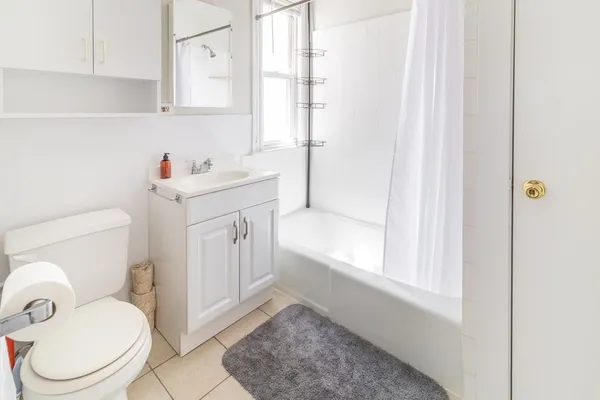 a bathroom with a sink toilet vanity and bathtub