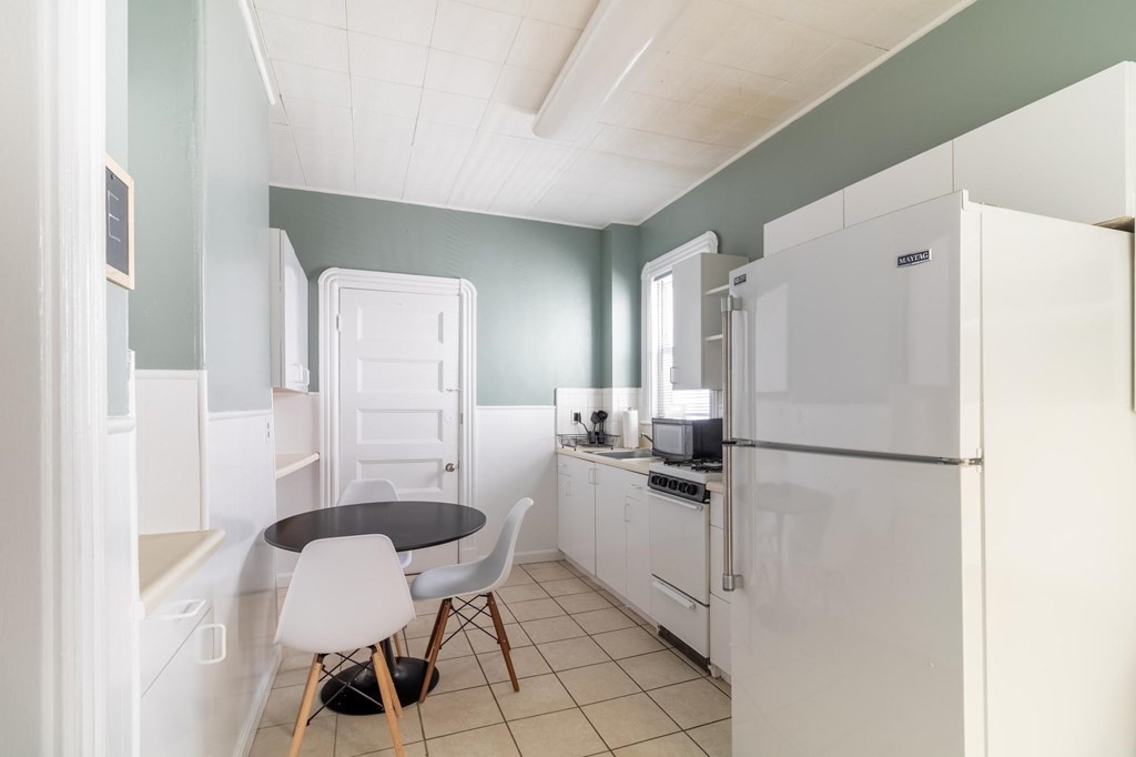 789 Columbia Road, Unit 2 Boston, MA 02125 - Photo 2 of 19 a kitchen with sink cabinets and refrigerator