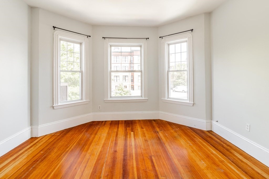 789 Columbia Road, Unit 2 Boston, MA 02125 - Photo 4 of 19 a view of empty room with wooden floor and fan