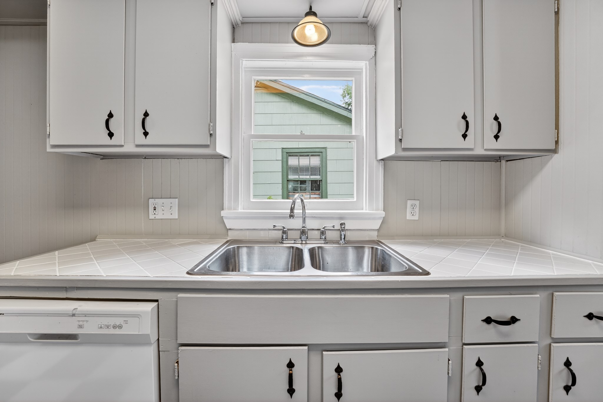 4907 Duval Street Austin, TX 78751 - Photo 11 of 31 a kitchen sink with white cabinets