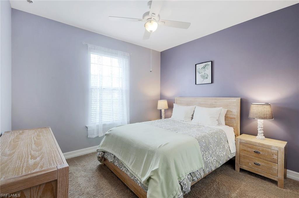 14374 Tuscany Pointe Trail Naples, FL 34120 - Photo 14 of 22 a bedroom with a bed and a night stand