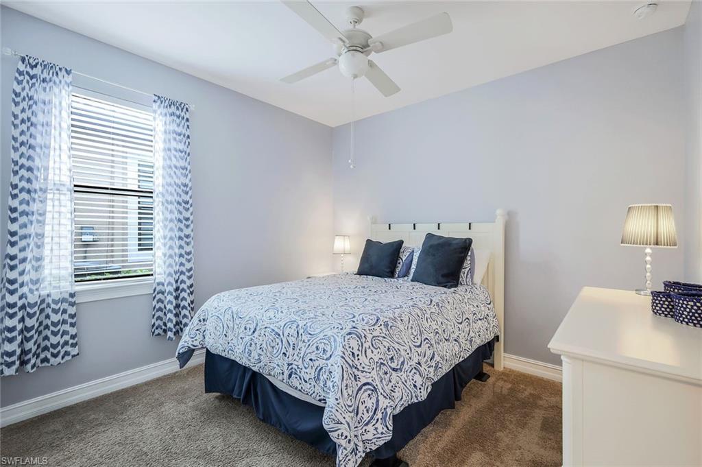14374 Tuscany Pointe Trail Naples, FL 34120 - Photo 16 of 22 a bedroom with a bed and a table in it