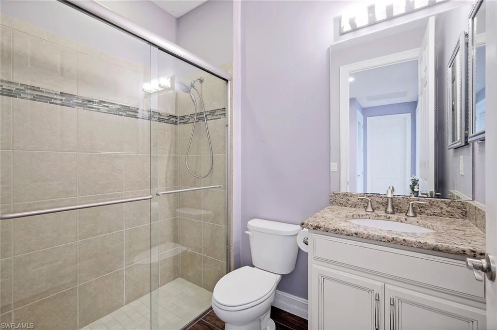 14374 Tuscany Pointe Trail Naples, FL 34120 - Photo 17 of 22 a bathroom with a granite countertop sink toilet and shower