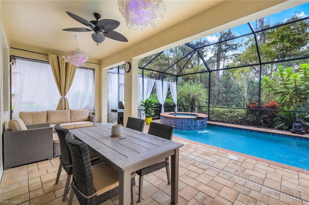 14374 Tuscany Pointe Trail Naples, FL 34120 - Photo 19 of 22 a view of a dining room with furniture window and wooden floor