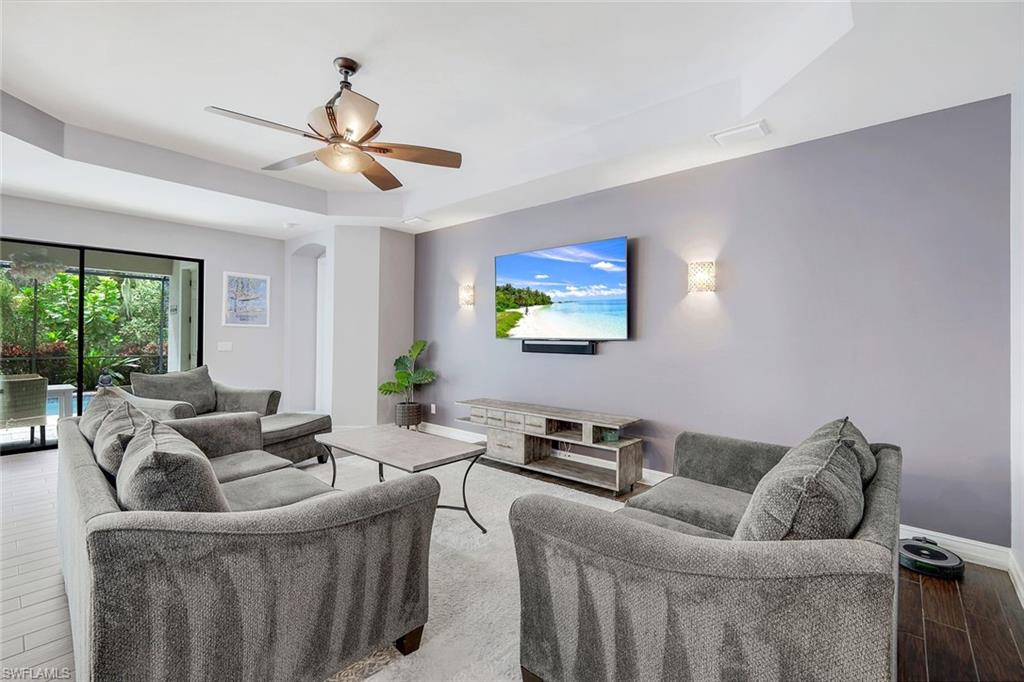 14374 Tuscany Pointe Trail Naples, FL 34120 - Photo 3 of 22 a living room with furniture and a flat screen tv