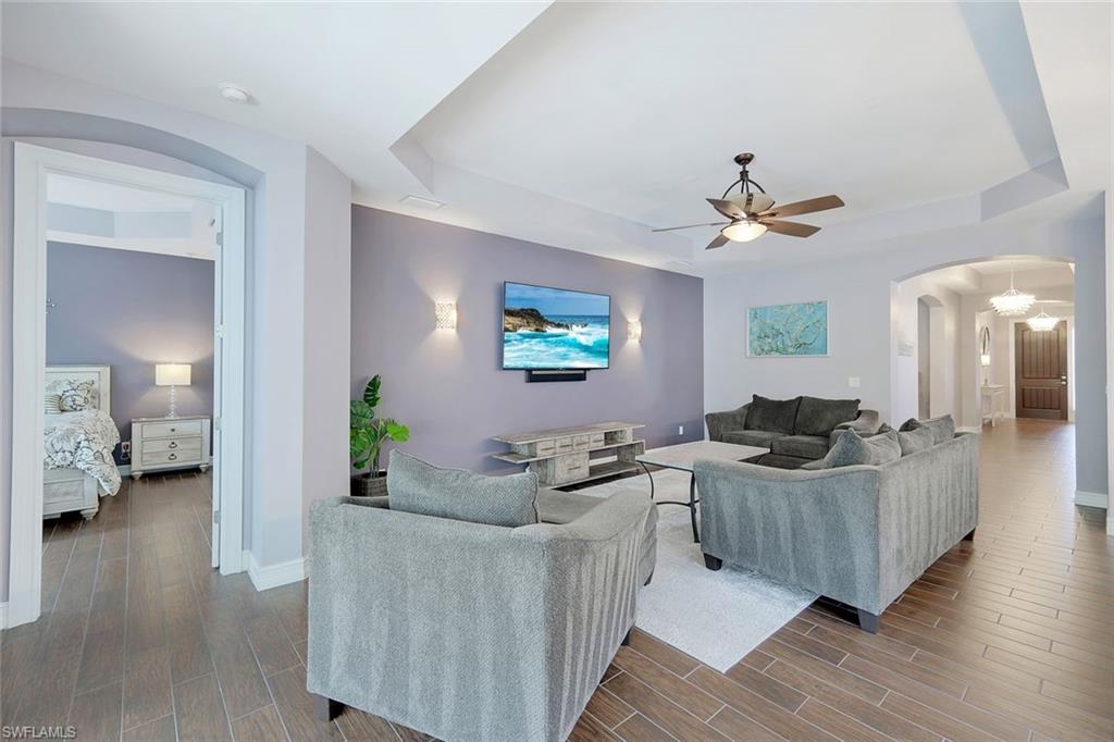 14374 Tuscany Pointe Trail Naples, FL 34120 - Photo 4 of 22 a living room with furniture and a flat screen tv