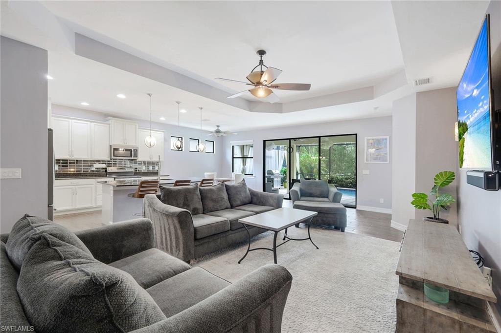 14374 Tuscany Pointe Trail Naples, FL 34120 - Photo 5 of 22 a living room with furniture kitchen view and a large window