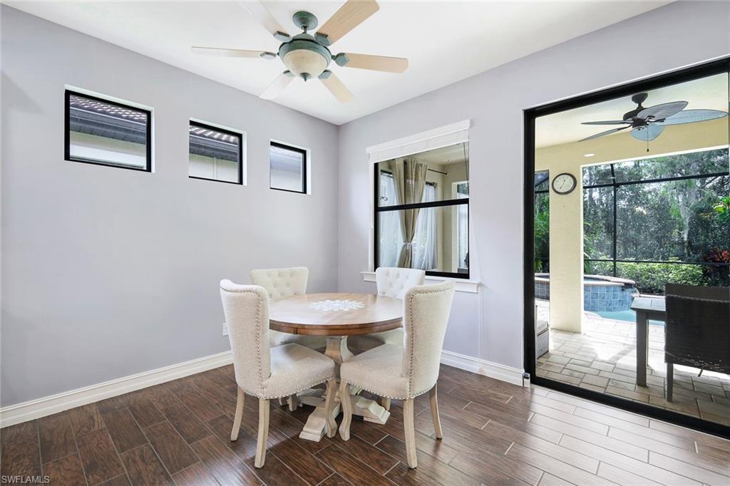 14374 Tuscany Pointe Trail Naples, FL 34120 - Photo 9 of 22 a view of a dining room with furniture window and wooden floor