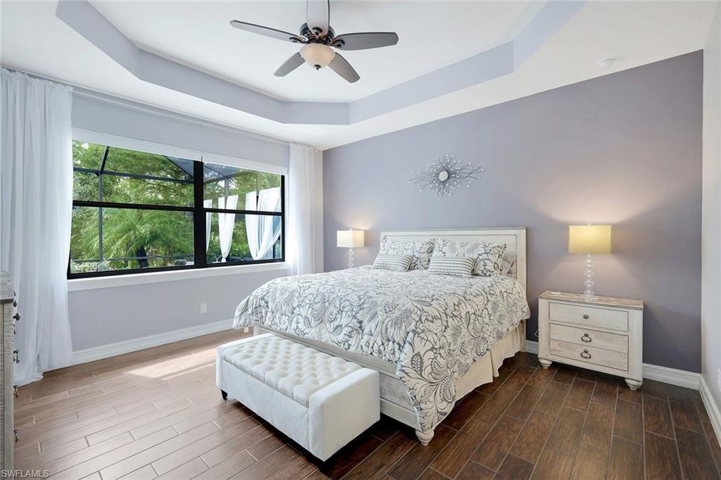 14374 Tuscany Pointe Trail Naples, FL 34120 - Photo 10 of 22 a bedroom with a bed couch and window