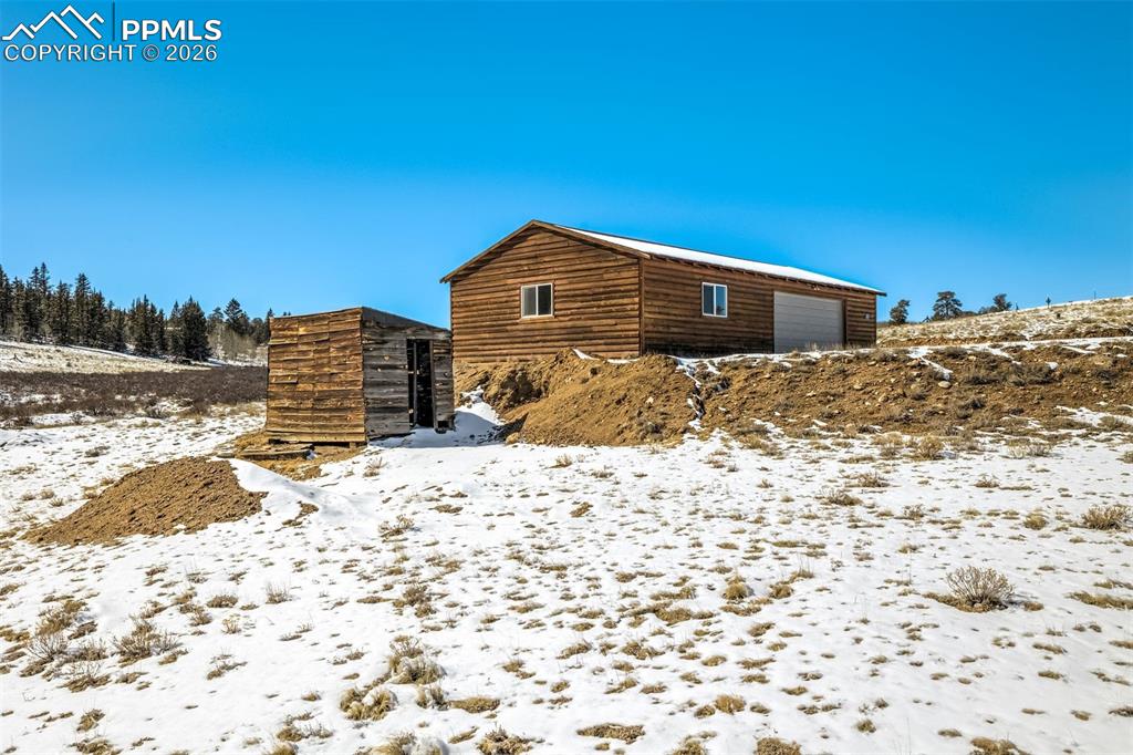 538 Remington Road Como, CO 80432 - Photo 5 of 19 a view of a wooden house with a yard