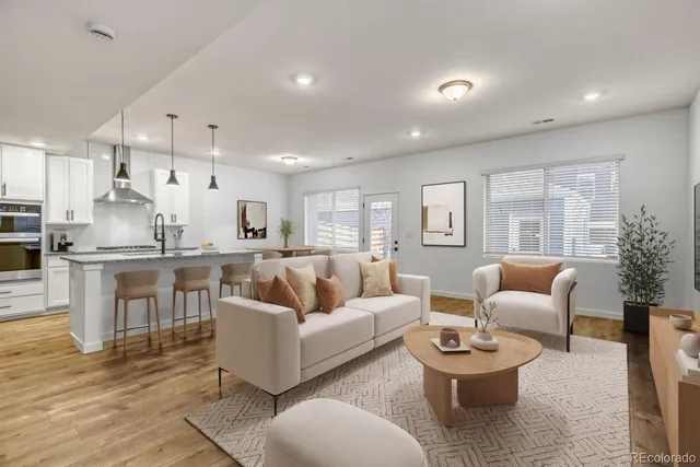 a living room with furniture and view of kitchen