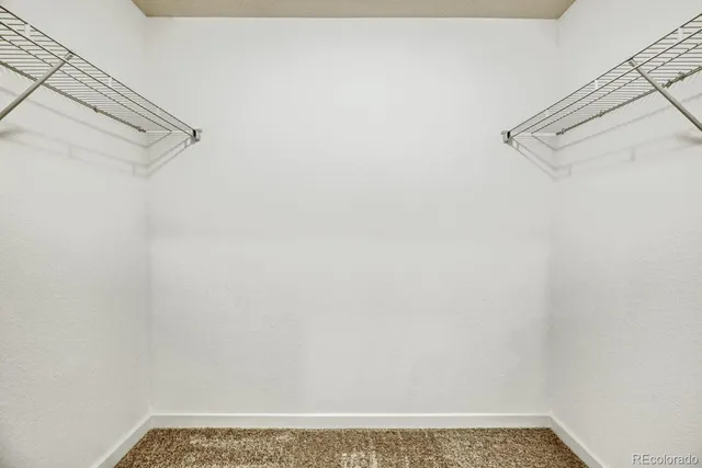 a bedroom with a bed and a potted plant